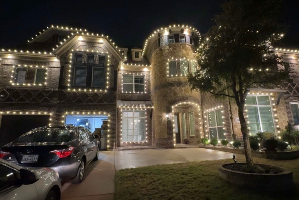 The Gutter Boys installation: a Texas home with warm-white lights along its roofline and windows