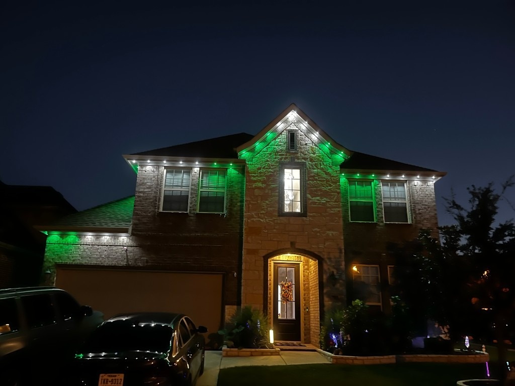 Green & white along the roofline Christmas lighting installation by The Gutter Boys