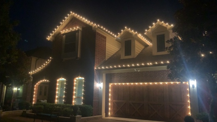 Warm-white peaks, windows & garage Christmas lighting installation by The Gutter Boys